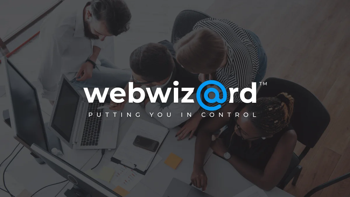 WebWiz@rd logo with team working in front of monitor in background